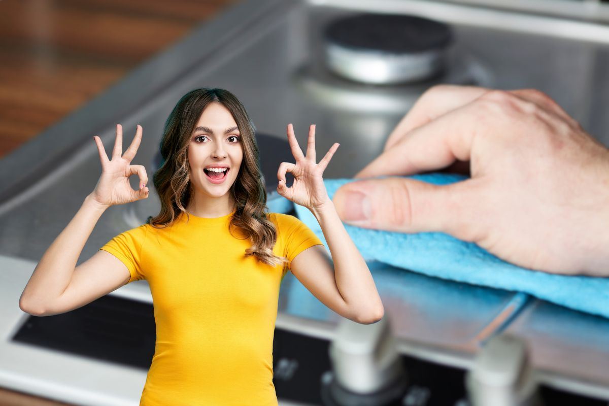 donna che fa ok e mano che pulisce piano cottura